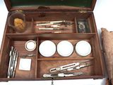 a wooden box with various tools in it on a table