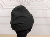 a black hat sitting on top of a wooden table