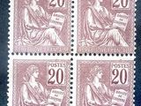four postage stamps with a woman sitting on a bench
