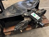 a close up of a fork attachment on a pallet in a garage