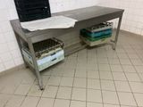 a metal table with baskets on top of it in a room