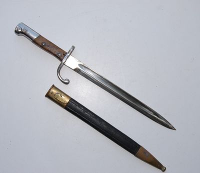 an old sword and a pencil on a white surface