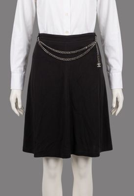 a white shirt and black skirt with a chain belt on a mannequin mannequin mannequin mannequin mannequin mannequin manne