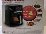 the box is open to show the inside of a small air fryer