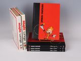 three books are stacked on top of each other on a white surface