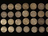 a lot of coins that are on a black surface