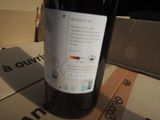 a bottle of wine sitting on top of a cardboard box