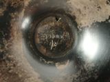 a close up of a metal bowl with a hole in it