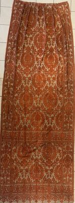 an orange skirt with a pattern on it sitting on top of a table