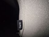 the back of a white chair with a black label on it