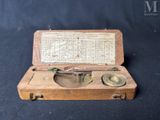an old wooden box with a compass on it on a black background