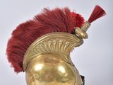 an image of a gold helmet with a red mohawk on it
