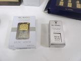 boxes of perfumes are sitting on a table next to a box of perfume