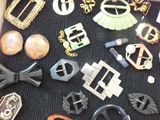 many different types of belts and buckles on a table