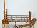 a wooden bed with a table and chairs in it