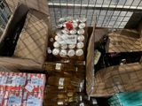 many boxes of beer sitting on the ground next to each other