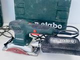 a corded sander and other tools sitting on a table