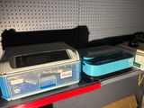two plastic containers sitting on a shelf next to a printer