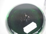 a close up of a green vase with a tag on it