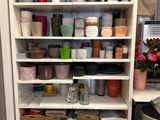 many pots and pans on the shelves in the kitchen
