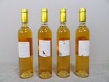 three bottles of wine are lined up on a table
