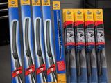 six wipe blades are sitting on a table in front of a shelf