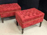 pair of red velvet foot stools on casteors with gold trim