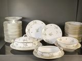 a lot of plates and bowls on the table