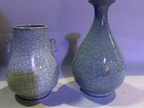 two vases that are sitting on a table