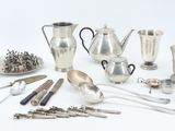 many different types of silverware on the table