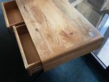 a table with a drawer on it in the middle of a room