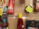 a cardboard box filled with condiments and condiments
