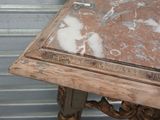 a marble top table with a wooden frame on it