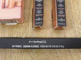 mac lip pencils and other makeup products on a wooden table