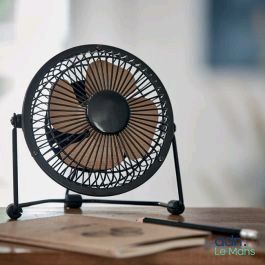 a small fan sitting on top of a wooden table
