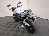 a white motorcycle that is parked on a black and white checkered floor
