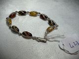 a close up of a bracelet on a table with a price tag