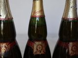 three bottles of champagne sitting next to each other on top of a table