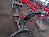 rows of red and black gym equipment in a large gym