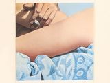 a polaroid picture of a woman laying on a bed