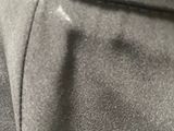 a close up of a person ' s hand holding a black purse