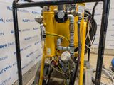 a machine that is sitting on the ground in front of a wall