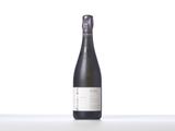 a bottle of wine sitting on top of a white table
