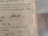 an old book with writing on it sitting on a table