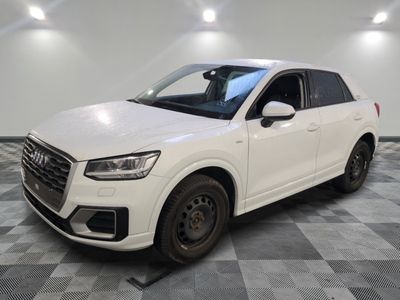 the white audi suv is parked in a clean room