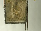a small tapestry hanging on the wall with a tassel