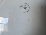 underside view of a white porcelain bowl with a black and white design on it