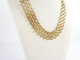 a close up of a mannequin necklace on a white mannequin