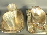 two silver trays with cups and spoons sitting on a table
