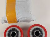 two red wheels and a white bag on a table